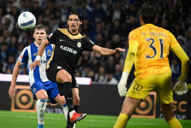 FC Porto's Polish midfielder #77 Oskar Pietuszewski (L) and FC Alverca's Moroccan forward # 02 Nabil Touaizi vie for the ball during the Portuguese League football match between FC Porto and FC Alverca at Dragao stadium in Porto, on May 2, 2026. (Photo by Miguel RIOPA / AFP)