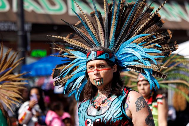 An Aztec dancer performs during the Cinco de Mayo parade in Saint Paul, Minnesota, on May 2, 2026. The Latino community in the Minneapolis-Saint Paul area is celebrating its first Cinco de Mayo since Immigration and Customs Enforcement (ICE) conducted large operations in early 2026. (Photo by Kerem YUCEL / AFP)