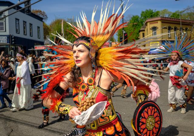 An Aztec dancer performs during the Cinco de Mayo parade in Saint Paul, Minnesota, on May 2, 2026. The Latino community in the Minneapolis-Saint Paul area is celebrating its first Cinco de Mayo since Immigration and Customs Enforcement (ICE) conducted large operations in early 2026. (Photo by Kerem YUCEL / AFP)