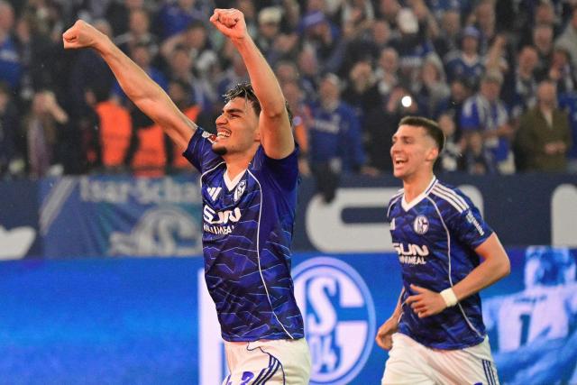 Schalke's players including Schalke's Turkish defender #43 Mertcan Ayhan (L) and Schalke's Argentine defender #02 Felipe Sanchez celebrate after the final whistle of the German second division Bundesliga football match between FC Schalke 04 and Fortuna Duesseldorf at the Veltins Arena in Gelsenkirchen, western Germany on May 2, 2026. Schalke will return to the first division next season after the win against Fortuna Duesseldorf on May 2, 2026. (Photo by INA FASSBENDER / AFP) / DFL REGULATIONS PROHIBIT ANY USE OF PHOTOGRAPHS AS IMAGE SEQUENCES AND/OR QUASI-VIDEO