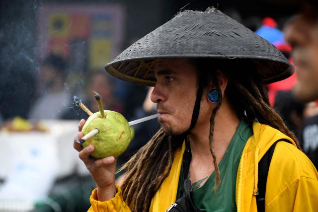 A n activist smokes a joint during the World Marijuana March in Medellin, Colombia, on May 2, 2026. (Photo by Jaime SALDARRIAGA / AFP)