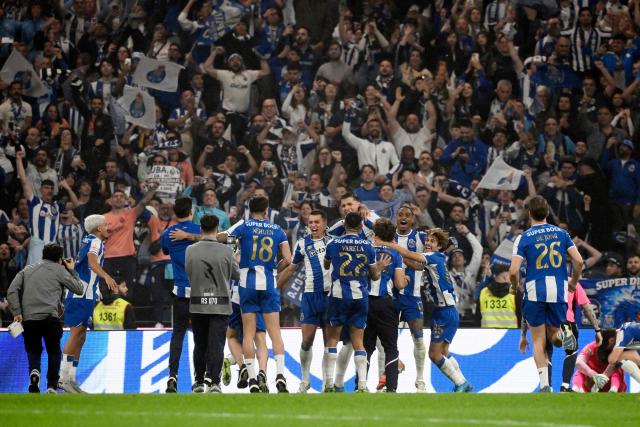 Porto players celebrate their victory at the end of the Portuguese League football match between FC Porto and FC Alverca at Dragao stadium in Porto, on May 2, 2026. Porto were crowned Portuguese champions with two games to spare after a 1-0 win over Alverca today. (Photo by Miguel RIOPA / AFP)