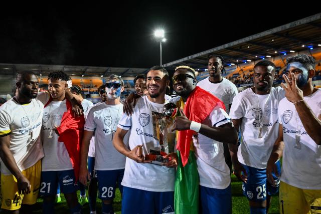 Troyes' players celebrate with the French Ligue 2 championship trophy after winning the French L2 football match between Troyes and Laval at the stade de l'Aube in Troyes, eastern France, on May 2, 2026. (Photo by ARNAUD FINISTRE / AFP)
