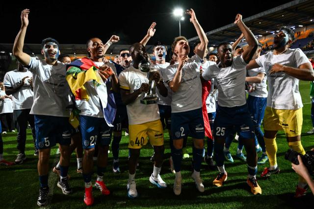 Troyes' players celebrate with the French Ligue 2 championship trophy after winning the French L2 football match between Troyes and Laval at the stade de l'Aube in Troyes, eastern France, on May 2, 2026. (Photo by ARNAUD FINISTRE / AFP)