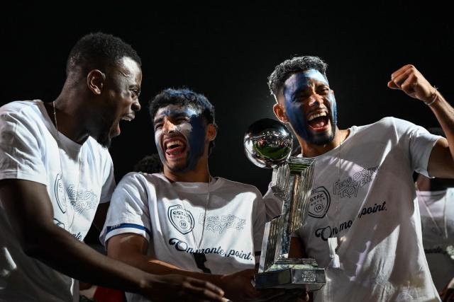 Troyes' players celebrate with the French Ligue 2 championship trophy after winning the French L2 football match between Troyes and Laval at the stade de l'Aube in Troyes, eastern France, on May 2, 2026. (Photo by ARNAUD FINISTRE / AFP)