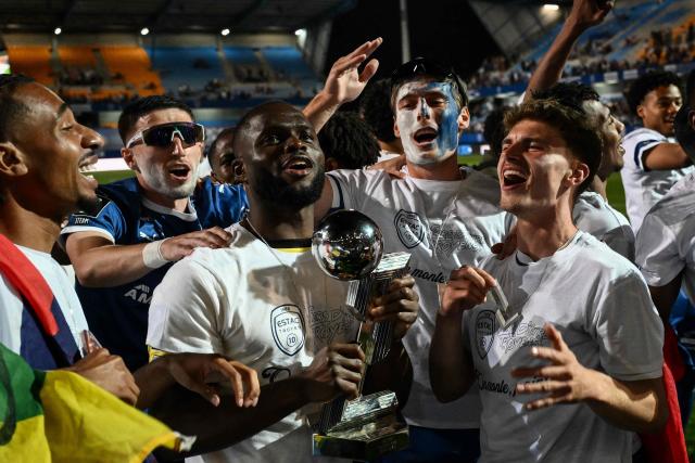 Troyes' players celebrate with the French Ligue 2 championship trophy after winning the French L2 football match between Troyes and Laval at the stade de l'Aube in Troyes, eastern France, on May 2, 2026. (Photo by ARNAUD FINISTRE / AFP)