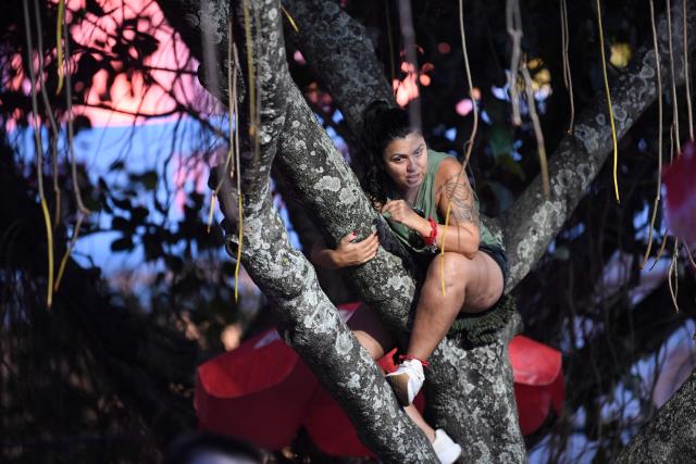 A fan climbs a tree near the stage on Copacabana Beach ahead of Colombian singer Shakira’s concert in Rio de Janeiro, Brazil, on May 2, 2026. (Photo by Daniel RAMALHO / AFP)