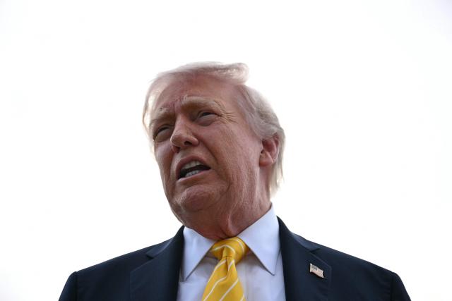 US President Donald Trump speaks with reporters at Palm Beach International Airport in West Palm Beach, Florida on May 2, 2026, before boarding Air Force One en route to Miami. (Photo by Jim WATSON / AFP)