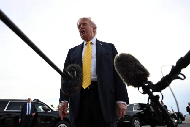 US President Donald Trump speaks with reporters at Palm Beach International Airport in West Palm Beach, Florida on May 2, 2026, before boarding Air Force One en route to Miami. (Photo by Jim WATSON / AFP)