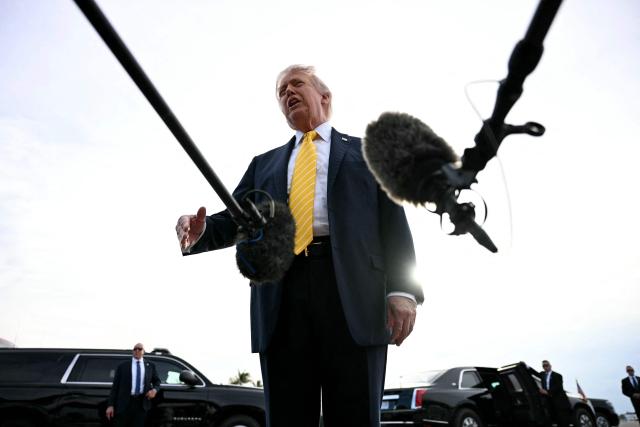 US President Donald Trump speaks with reporters at Palm Beach International Airport in West Palm Beach, Florida on May 2, 2026, before boarding Air Force One en route to Miami. (Photo by Jim WATSON / AFP)