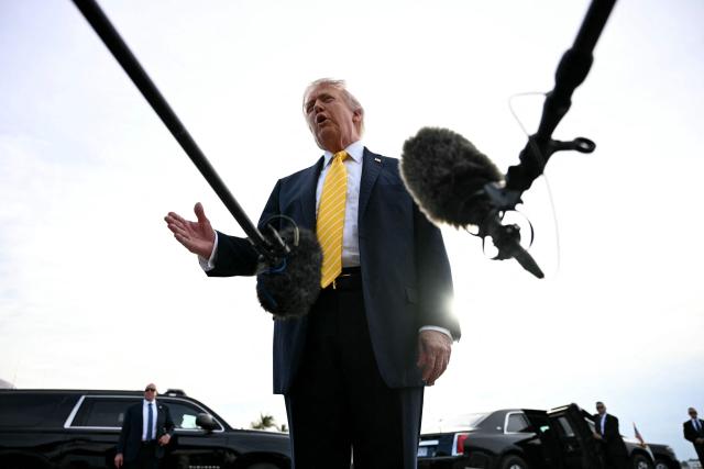 US President Donald Trump speaks with reporters at Palm Beach International Airport in West Palm Beach, Florida on May 2, 2026, before boarding Air Force One en route to Miami. (Photo by Jim WATSON / AFP)