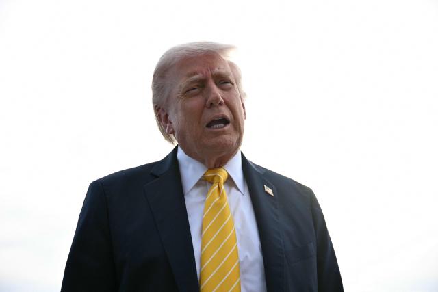 US President Donald Trump speaks with reporters at Palm Beach International Airport in West Palm Beach, Florida on May 2, 2026, before boarding Air Force One en route to Miami. (Photo by Jim WATSON / AFP)