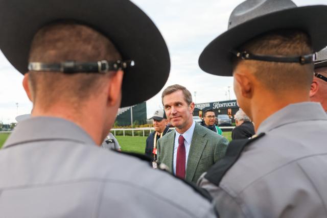 Kentucky Governor Andy Beshear speaks with state troopers during the 152nd running of the Kentucky Derby at Churchill Downs in Louisville, Kentucky, on May 2, 2026. (Photo by Leandro Lozada / AFP)