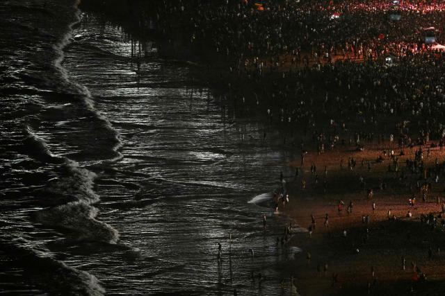 Fans enjoy the beach while waiting for the start of the concert of Colombian singer Shakira, at Copacabana beach in Rio de Janeiro, Brazil on May 2, 2026. (Photo by Mauro PIMENTEL / AFP)