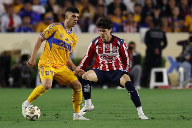 Tigres' Argentine midfielder #11 Juan Brunetta and Guadalajara's defender #19 Diego Campillo fight for the ball during the Mexican League quarterfinal first leg football match between Tigres and Guadalajara at the Universitario stadium in Monterrey, Nuevo Leon state, Mexico on May 2, 2026. (Photo by Julio Cesar AGUILAR / AFP)
