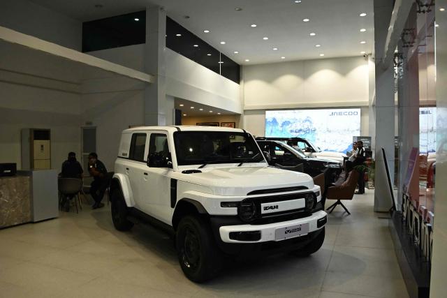 This photograph taken on April 29, 2026 shows a model of the iCAR V23 electric vehicle at a showroom of Chinese automaker Jaecoo in Kathmandu. As global fuel markets reel from the Middle East war, motorists in Nepal are increasingly turning to electric vehicles, with high demand putting a strain on dealerships. (Photo by Prakash MATHEMA / AFP) / TO GO WITH 'Nepal-Transport-Automobile-Energy' FOCUS