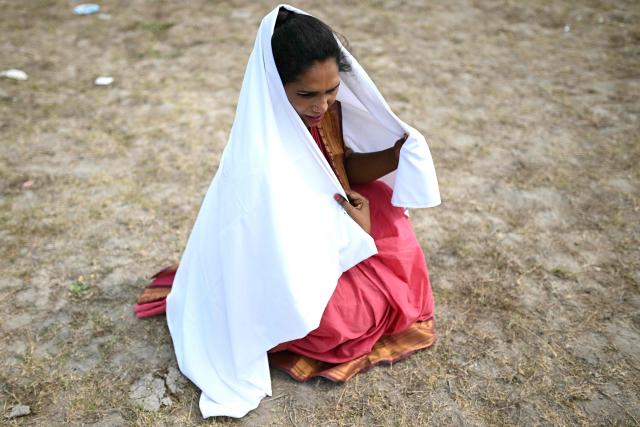 This photograph taken on April 29, 2026 shows Thilothama, a member of the transgender community mourning wearing a white cloth symbolising end of her marriage to Hindu warrior god Aravan during the annual Koovagam transgender festival at the Koothandavar temple in Tamil Nadu's Kallakurichi district. For a few fleeting days each year, at the heart of the Koothandavar Temple where ostracised transgender community members from across India come to honour the Hindu deity Aravan, a tradition rooted in millennia-old Hindu texts -- and to enjoy a brief oasis of freedom, for the past 10 years Thilothama has returned to Koovagam, where a beauty pageant and singing contests are held alongside religious rituals. (Photo by R.Satish BABU / AFP)
