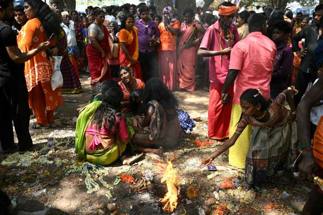 This photograph taken on April 29, 2026 shows members of the transgender community mourning after a priest cut the "thali", a sacred thread symbolising end of their marriage to Hindu warrior god Aravan during the annual Koovagam transgender festival at the Koothandavar temple in Tamil Nadu's Kallakurichi district. For a few fleeting days each year, at the heart of the Koothandavar Temple where ostracised transgender community members from across India come to honour the Hindu deity Aravan, a tradition rooted in millennia-old Hindu texts -- and to enjoy a brief oasis of freedom. (Photo by R.Satish BABU / AFP)