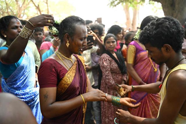 This photograph taken on April 29, 2026 shows a member of the transgender community mourning as a priest cuts the "thali", a sacred thread symbolising end of her marriage to Hindu warrior god Aravan during the annual Koovagam transgender festival at the Koothandavar temple in Tamil Nadu's Kallakurichi district. For a few fleeting days each year, at the heart of the Koothandavar Temple where ostracised transgender community members from across India come to honour the Hindu deity Aravan, a tradition rooted in millennia-old Hindu texts -- and to enjoy a brief oasis of freedom. (Photo by R.Satish BABU / AFP)