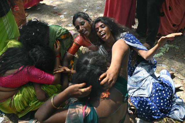 This photograph taken on April 29, 2026 shows members of the transgender community mourning after a priest cut the "thali", a sacred thread symbolising end of their marriage to Hindu warrior god Aravan during the annual Koovagam transgender festival at the Koothandavar temple in Tamil Nadu's Kallakurichi district. For a few fleeting days each year, at the heart of the Koothandavar Temple where ostracised transgender community members from across India come to honour the Hindu deity Aravan, a tradition rooted in millennia-old Hindu texts -- and to enjoy a brief oasis of freedom. (Photo by R.Satish BABU / AFP)
