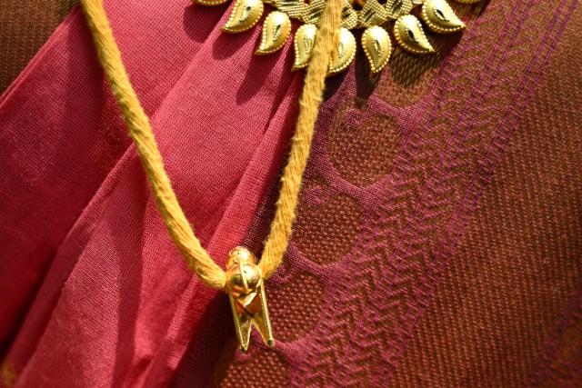 This photograph taken on April 29, 2026 shows Thilothama, a member of the transgender community wearing "thali", a sacred thread symbolising her marriage to Hindu warrior god Aravan during the annual Koovagam transgender festival at the Koothandavar temple in Tamil Nadu's Kallakurichi district. For a few fleeting days each year, at the heart of the Koothandavar Temple where ostracised transgender community members from across India come to honour the Hindu deity Aravan, a tradition rooted in millennia-old Hindu texts -- and to enjoy a brief oasis of freedom, for the past 10 years Thilothama has returned to Koovagam, where a beauty pageant and singing contests are held alongside religious rituals. (Photo by R.Satish BABU / AFP)