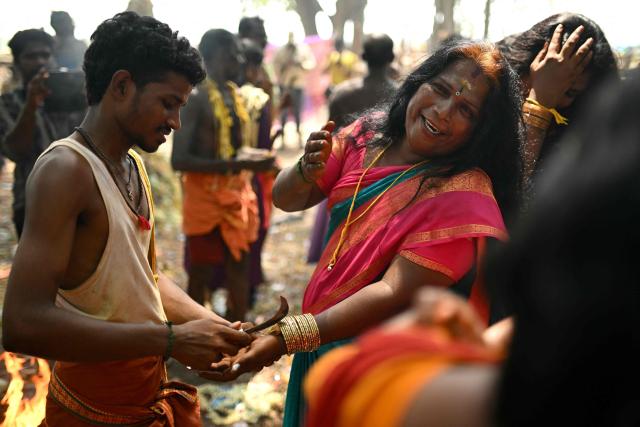 This photograph taken on April 29, 2026 shows a member of the transgender community mourning as a priest cuts the "thali", a sacred thread symbolising end of her marriage to Hindu warrior god Aravan during the annual Koovagam transgender festival at the Koothandavar temple in Tamil Nadu's Kallakurichi district. For a few fleeting days each year, at the heart of the Koothandavar Temple where ostracised transgender community members from across India come to honour the Hindu deity Aravan, a tradition rooted in millennia-old Hindu texts -- and to enjoy a brief oasis of freedom. (Photo by R.Satish BABU / AFP)