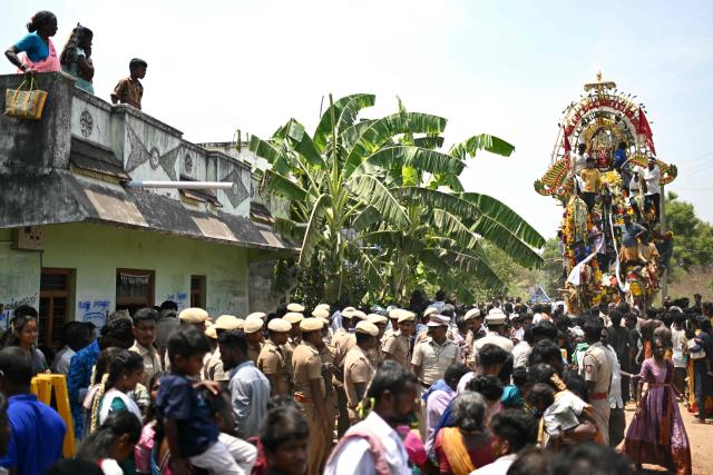 This photograph taken on April 29, 2026 shows members of the transgender community and devotees offering prayers to a chariot procession of Hindu warrior god Aravan during the annual Koovagam transgender festival at the Koothandavar temple in Tamil Nadu's Kallakurichi district. For a few fleeting days each year, at the heart of the Koothandavar Temple where ostracised transgender community members from across India come to honour the Hindu deity Aravan, a tradition rooted in millennia-old Hindu texts -- and to enjoy a brief oasis of freedom. (Photo by R.Satish BABU / AFP)