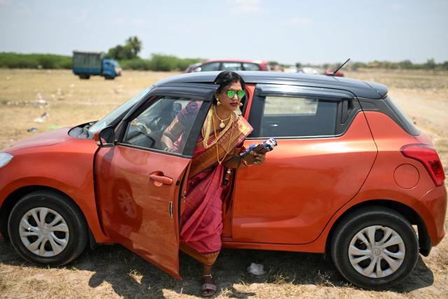 This photograph taken on April 29, 2026 shows Thilothama, a member of the transgender community arriving to get "thali" removed, a sacred thread tied to her neck symbolising end of her marriage to Hindu warrior god Aravan during the annual Koovagam transgender festival at the Koothandavar temple in Tamil Nadu's Kallakurichi district. For a few fleeting days each year, at the heart of the Koothandavar Temple where ostracised transgender community members from across India come to honour the Hindu deity Aravan, a tradition rooted in millennia-old Hindu texts -- and to enjoy a brief oasis of freedom, for the past 10 years Thilothama has returned to Koovagam, where a beauty pageant and singing contests are held alongside religious rituals. (Photo by R.Satish BABU / AFP)