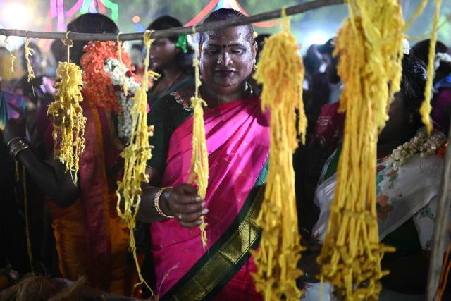 This photograph taken on April 28, 2026 shows a member of the transgender community buying "thali", a sacred thread symbolising marriage to Hindu warrior god Aravan during the annual Koovagam transgender festival at the Koothandavar temple in Tamil Nadu's Kallakurichi district. For a few fleeting days each year, at the heart of the Koothandavar Temple where ostracised transgender community members from across India come to honour the Hindu deity Aravan, a tradition rooted in millennia-old Hindu texts -- and to enjoy a brief oasis of freedom. (Photo by R.Satish BABU / AFP)