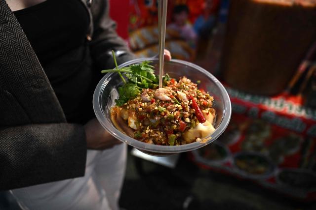 This photo taken on April 29, 2026 shows grilled seafood salad from a street food vendor in Chinatown in Bangkok. Across Bangkok, aromas of garlic, chilli and grilled meat drift from roadside stalls and carts, but tighter controls on vendors threaten livelihoods and the street food culture that defines the Thai capital. (Photo by Lillian SUWANRUMPHA / AFP) / To go with AFP story Thailand-Bangkok-food-culture-economy,FOCUS by Montira Rungjirajittranon