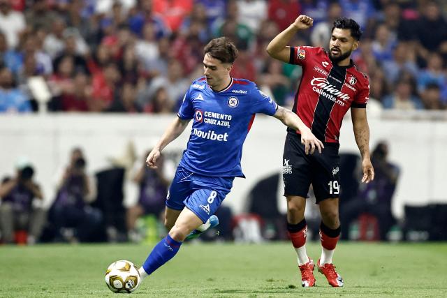 Cruz Azul's Argentine midfielder #08 Agustin Palavecino and Atlas' forward #19 Eduardo Aguirre fight for the ball during the Mexican League Clausura Tournament quarterfinal first leg football match between Atlas and Cruz Azul at the Jalisco stadium in Guadalajara, Jalisco state, Mexico on May 2, 2026. (Photo by Ulises RUIZ / AFP)