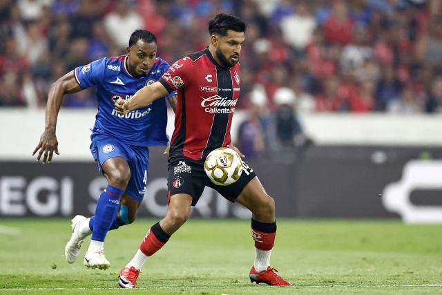 Cruz Azul's Colombian defender #04 Willer Ditta and Atlas' forward #19 Eduardo Aguirre fight for the ball during the Mexican League Clausura Tournament quarterfinal first leg football match between Atlas and Cruz Azul at the Jalisco stadium in Guadalajara, Jalisco state, Mexico on May 2, 2026. (Photo by Ulises RUIZ / AFP)