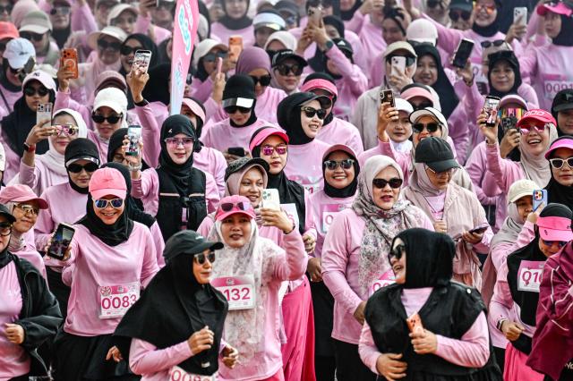 Women runners take part in a 'She Runes the World' event at Harapan Bangsa stadium in Banda Aceh on May 3, 2026. (Photo by CHAIDEER MAHYUDDIN / AFP)