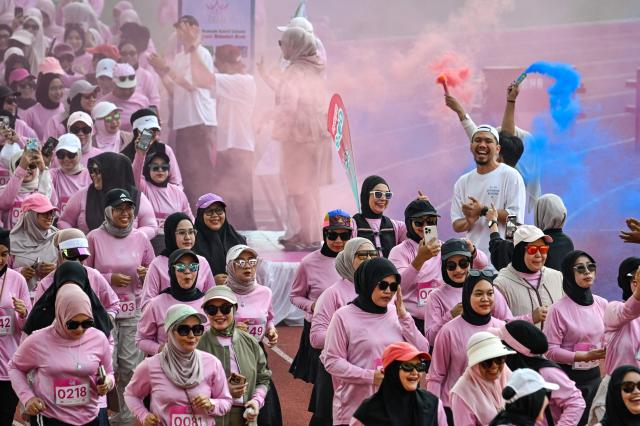 Women runners take part in a 'She Runes the World' event at Harapan Bangsa stadium in Banda Aceh on May 3, 2026. (Photo by CHAIDEER MAHYUDDIN / AFP)