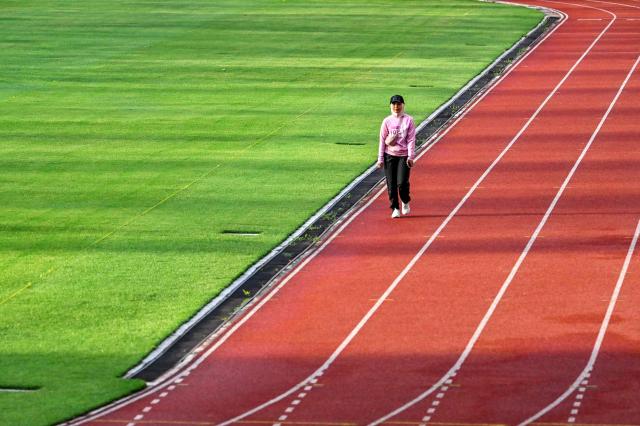 A woman takes part in a 'She Runes the World' event at Harapan Bangsa stadium in Banda Aceh on May 3, 2026. (Photo by CHAIDEER MAHYUDDIN / AFP)
