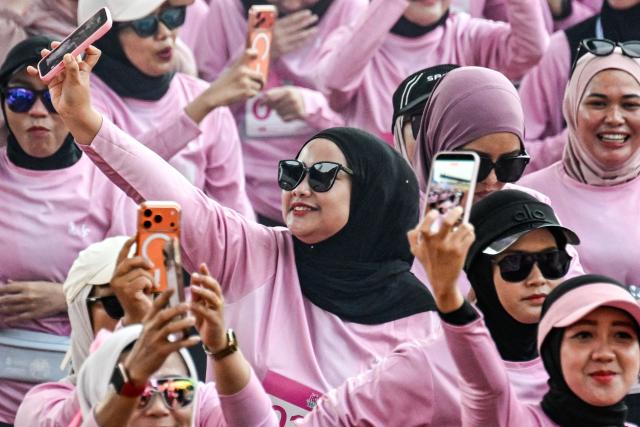 Women runners take part in a 'She Runes the World' event at Harapan Bangsa stadium in Banda Aceh on May 3, 2026. (Photo by CHAIDEER MAHYUDDIN / AFP)