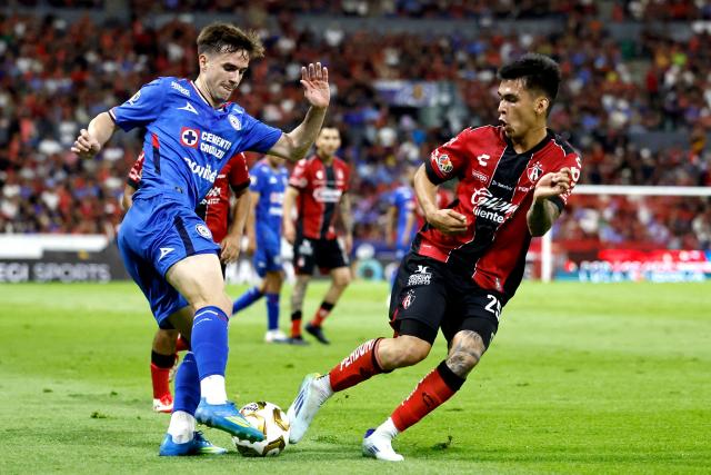 Cruz Azul's Argentine midfielder #08 Agustin Palavecino and Atlas' forward #25 Jorge Rodriguez fight for the ball during the Mexican League Clausura Tournament quarterfinal first leg football match between Atlas and Cruz Azul at the Jalisco stadium in Guadalajara, Jalisco state, Mexico on May 2, 2026. (Photo by Ulises RUIZ / AFP)