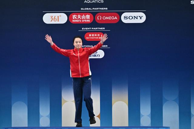China’s Chen Jia celebrates on the podium after winning the women’s 3m springboard event at the World Aquatics Diving World Cup Super Finals in Beijing on May 3, 2026. (Photo by Pedro Pardo / AFP)