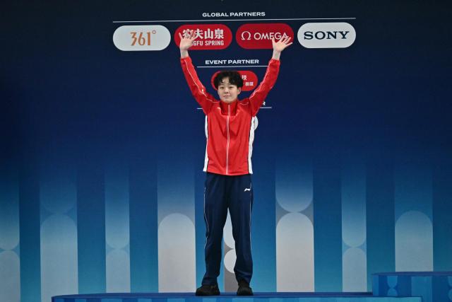 China’s Chen Yiwen celebrates on the podium her second place after the women’s 3m springboard event at the World Aquatics Diving World Cup Super Finals in Beijing on May 3, 2026. (Photo by Pedro Pardo / AFP)