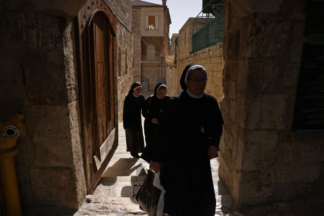 Nuns walk on their way to the Church of the Holy Sepulchre in the old city of Jerusalem on May 3, 2026. (Photo by HAZEM BADER / AFP)