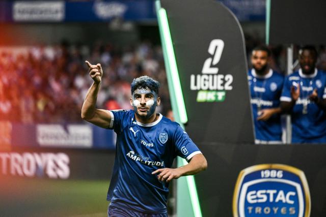Troyes’ French midfielder #05 Martin Adeline celebrates as his team wins the French Ligue 2 championship trophy following the French L2 football match between Troyes and Laval at the stade de l'Aube in Troyes, eastern France, on May 2, 2026. (Photo by ARNAUD FINISTRE / AFP)