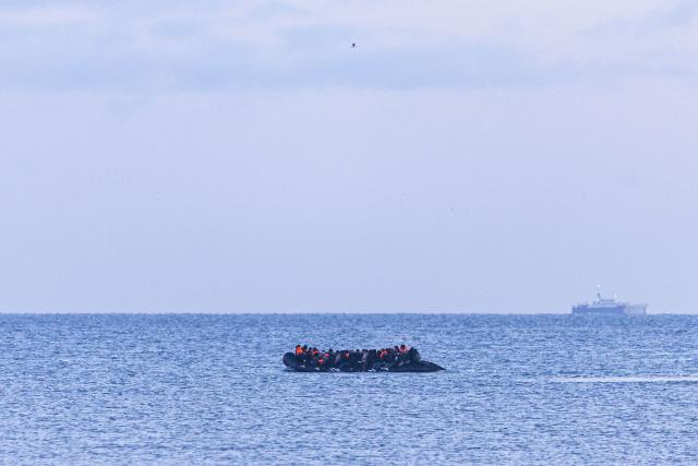 (FILES) Migrants attempt to cross the English Channel in a smuggler's boat off the coast of Gravelines, northern France, on April 14, 2026. Two women died on May 3, 2026 while trying to reach Britain from northern France in a small boat, officials said. The pair of would-be migrants were among 82 people packed on the boat that "ran aground" on a beach at Neufchatel-Hardelot, about 12 kilometres (seven miles) south of the port of Boulogne, said Christophe Marx, a regional government official. (Photo by Sameer Al-DOUMY / AFP)