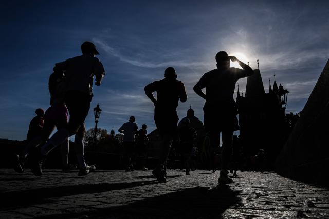 Participants run across the Charles Bridge during the Prague marathon on May 3, 2026 in Prague, Czech Republic. (Photo by Michal Cizek / AFP)