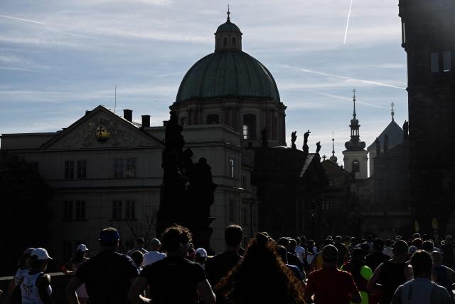 Participants run across the Charles Bridge during the Prague marathon on May 3, 2026 in Prague, Czech Republic. (Photo by Michal Cizek / AFP)