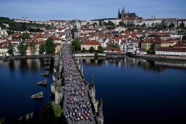 Participants run across the Charles Bridge during the Prague marathon on May 3, 2026 in Prague, Czech Republic. (Photo by Michal Cizek / AFP)