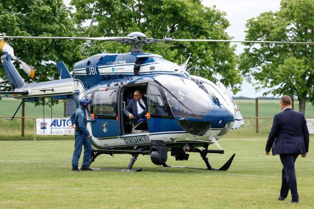France's Interior Minister Laurent Nunez (C) disembarks from a Gendarmerie Eurocopter EC145 helicopter after flying over the site of a "teknival" rave party at a military site in Cornusse, near Bourges, central France on May 3, 2026. Between 17,000 and 40,000 people participate in the free party which has been taking place, without major incident, since May 1, 2026. The gathering comes as the French parliament is seeking to tighten legislation against unauthorised rave parties, introducing prison sentences for organisers and fines for attendees. (Photo by Kenzo TRIBOUILLARD / AFP)