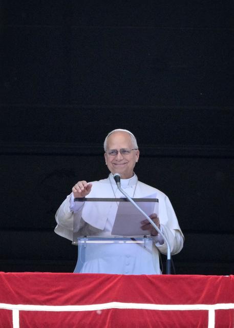 Pope Leo XIV addresses the crowd from a window of the Apostolic Palace overlooking St. Peter's Square during the Regina Caeli prayer in the Vatican on May 3, 2026. (Photo by TIZIANA FABI / AFP)