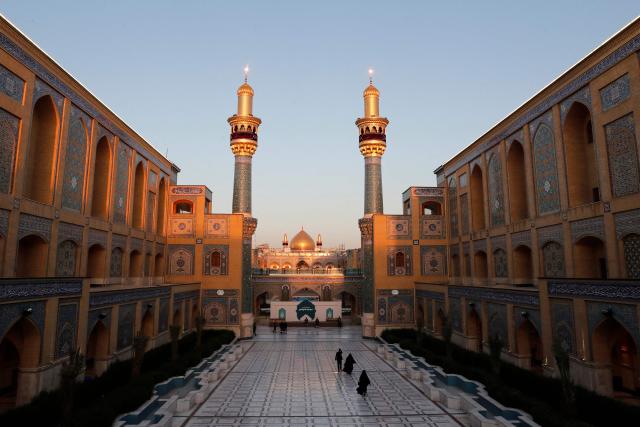 (FILES) Shia Muslims visit the Imam Ali Shrine during the Muslim fasting month of Ramadan in Najaf on March 10, 2026, on the anniversary of the death of Ali bin Abi Taleb, the cousin, son-in-law and companion of the Prophet Muhammad. In Iraq's holy city of Najaf, the majestic shrine of Imam Ali stands quieter than usual, its vast courtyards no longer filled with pilgrims whose whispers once echoed, melding in different languages. Typically, millions of Shia Muslims from around the world flock to Iraq's holy cities of Najaf and Karbala every year. But the Middle East war, ignited by a joint US-Israeli attack on Iran on February 28, has stemmed the usual influx of pilgrims from Iran, Lebanon, Gulf states, India, Afghanistan and elsewhere. (Photo by AHMAD AL-RUBAYE / AFP)