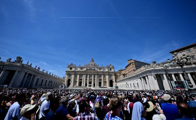 Pope Leo XIV addresses the crowd from a window of the Apostolic Palace overlooking St. Peter's Square during the Regina Caeli prayer in the Vatican on May 3, 2026. (Photo by TIZIANA FABI / AFP)