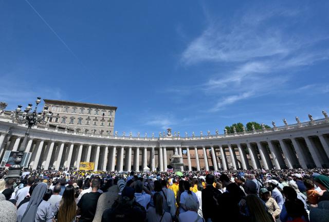 Pope Leo XIV addresses the crowd from a window of the Apostolic Palace overlooking St. Peter's Square during the Regina Caeli prayer in the Vatican on May 3, 2026. (Photo by TIZIANA FABI / AFP)